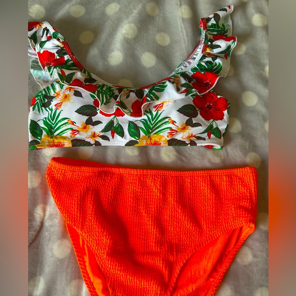 A tropical themed swimsuit set! With a floral top and bright orange bottoms. :)
